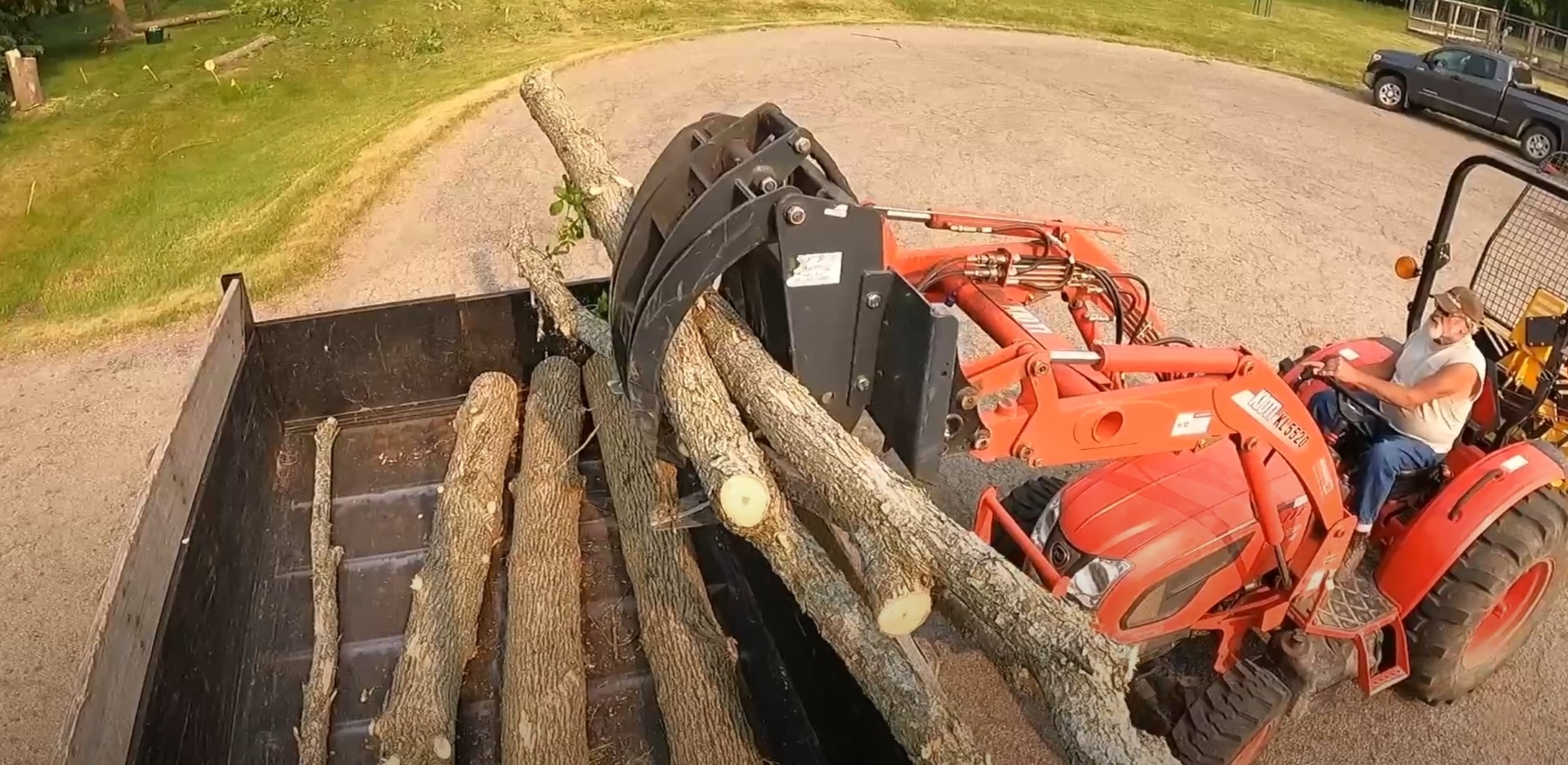 Complete tree removal and hauling services Heavy equipment loading cut tree logs for removal