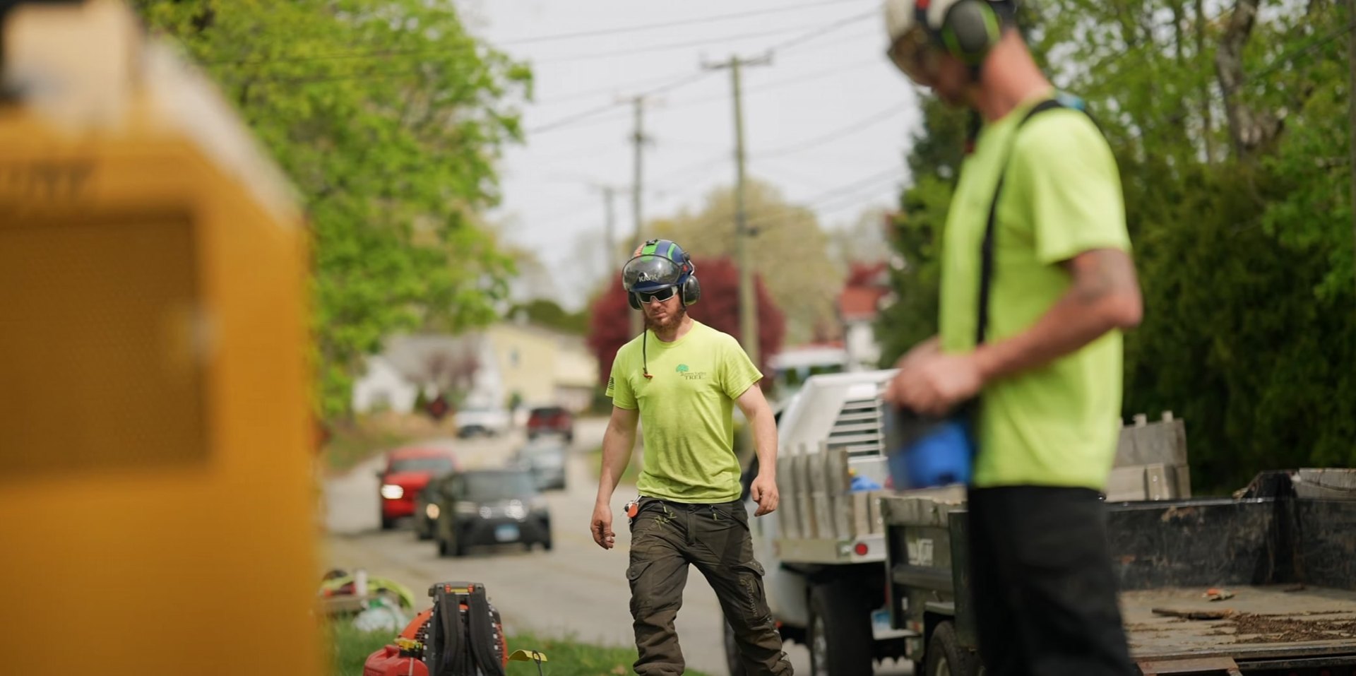 Licensed tree service team ensuring safety in residential areas Tree service crew working on residential street with safety equipment